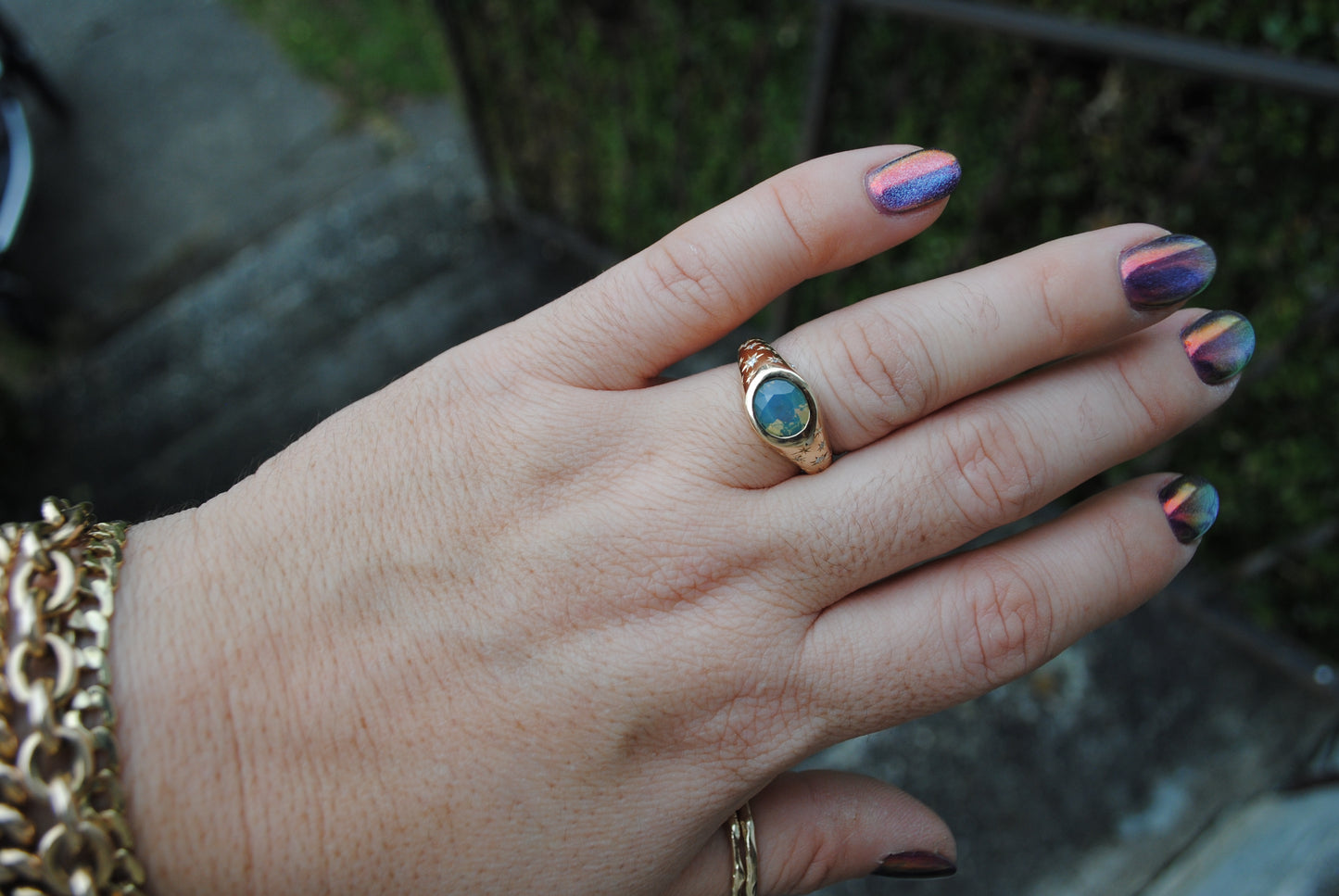 2.15 carat opalescent blue and green sapphire with engraved stars