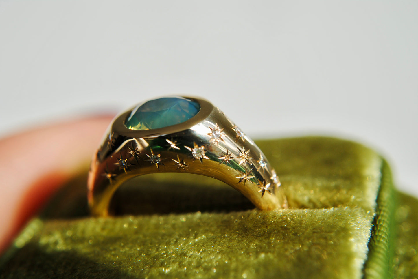 2.15 carat opalescent blue and green sapphire with engraved stars