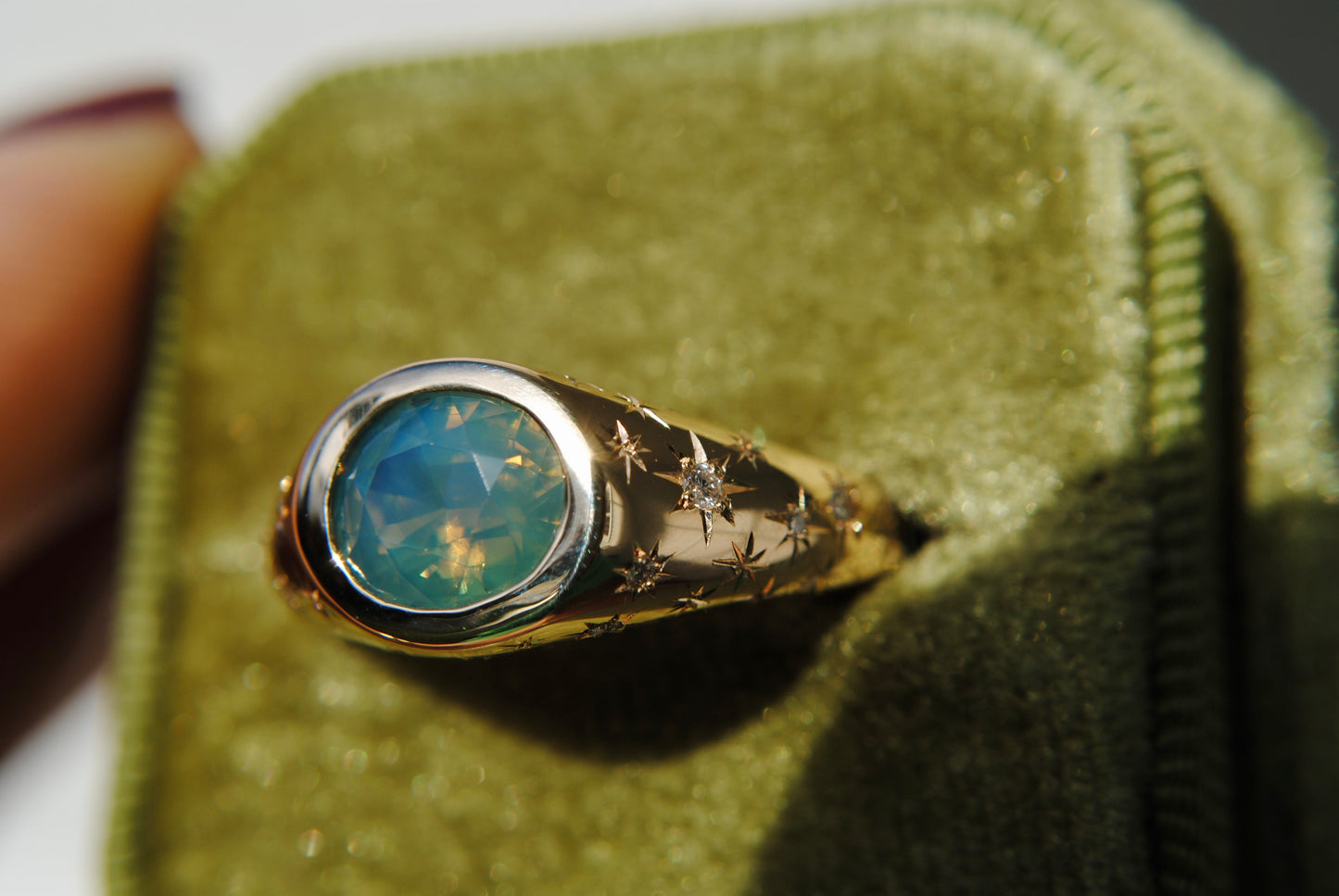 2.15 carat opalescent blue and green sapphire with engraved stars