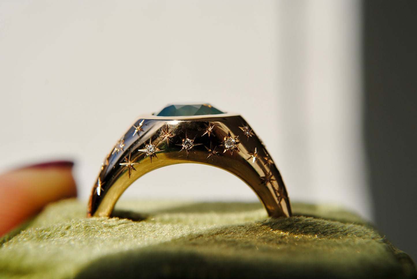 2.15 carat opalescent blue and green sapphire with engraved stars