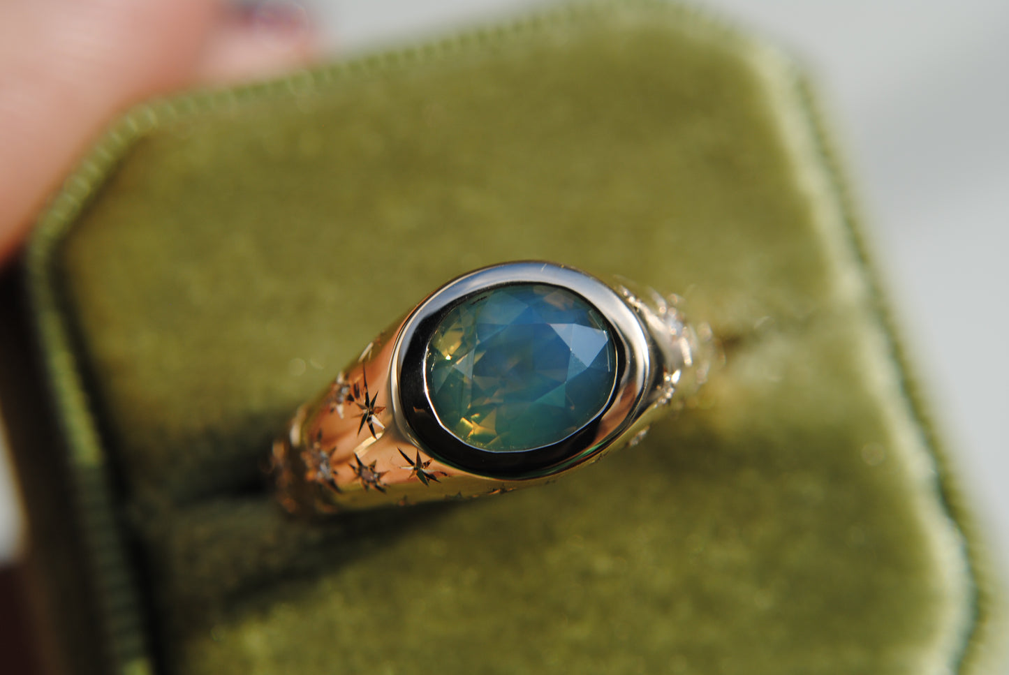 2.15 carat opalescent blue and green sapphire with engraved stars