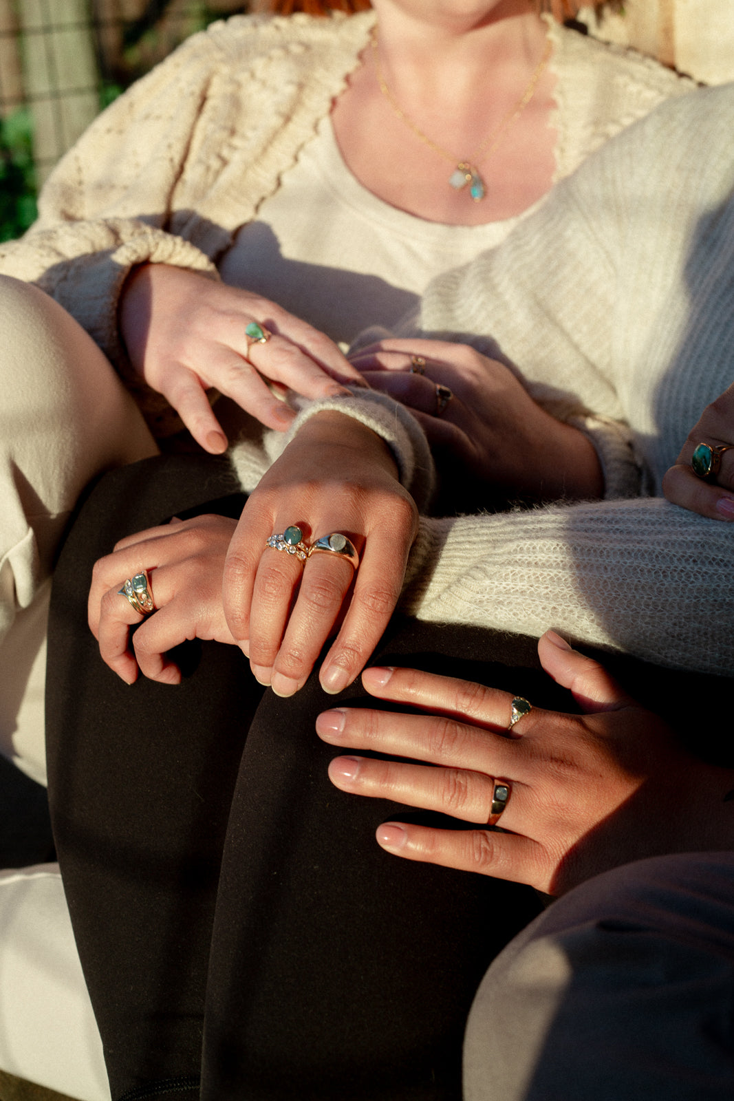 image is of multiple models wearing jewelry at sunset